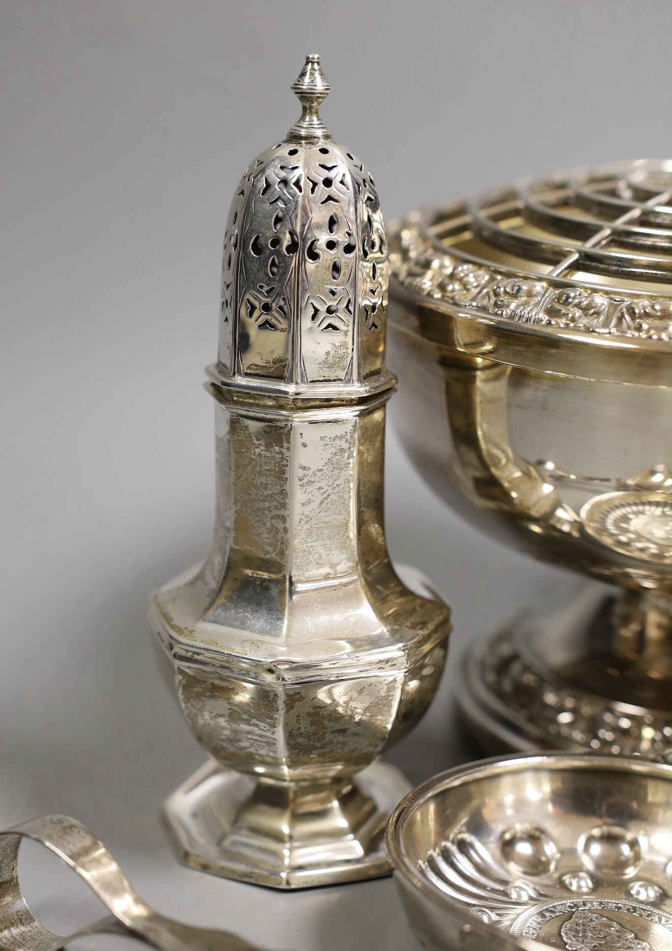 A George III silver vase shaped pepperette, Richard Evans? London, 1788, 88mm, a Victorian silver christening mug, a later silver sugar caster, a French white metal taste vin and other sundry silver and plated items.